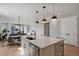 Modern kitchen with white cabinets, stainless steel appliances, and a large island at 5271 Routt Ct, Arvada, CO 80002