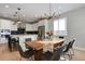Eat in kitchen features modern light fixture, black barstools, and stainless steel appliances at 5271 Routt Ct, Arvada, CO 80002