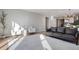 Open-concept living room with neutral tones, sleek furniture, and lots of natural light at 5271 Routt Ct, Arvada, CO 80002