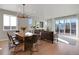 Open concept living room with direct view to sliding glass doors, dining area, and living area at 5271 Routt Ct, Arvada, CO 80002