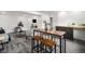 Basement with a wet bar, wooden dining table, and gray carpet at 6775 Newland St, Arvada, CO 80003
