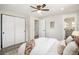 Light-filled bedroom with ensuite bath featuring a ceiling fan, closet space, and neutral décor for a relaxing retreat at 6775 Newland St, Arvada, CO 80003