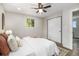 Bright bedroom featuring a ceiling fan, plush bedding, and a closet with mirrored doors for added convenience at 6775 Newland St, Arvada, CO 80003