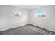 This bedroom is bright with two windows and comfortable carpet at 6775 Newland St, Arvada, CO 80003