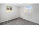 Bright bedroom offers carpet flooring and natural light from its two windows at 6775 Newland St, Arvada, CO 80003