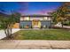 Charming home featuring a well-manicured lawn, modern exterior paint, and a pergola over the front door at 6775 Newland St, Arvada, CO 80003