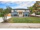 Charming home featuring a well-manicured lawn, modern exterior paint, and a pergola over the front door at 6775 Newland St, Arvada, CO 80003