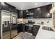 Contemporary kitchen featuring stainless steel appliances, dark cabinets, and ample counter space with stylish decor at 6775 Newland St, Arvada, CO 80003