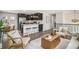 Open-concept living room and kitchen featuring modern design, stylish furniture, and stainless steel appliances at 6775 Newland St, Arvada, CO 80003