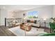Bright living room featuring modern furniture, a large window, and stylish decor at 6775 Newland St, Arvada, CO 80003