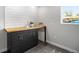 Modern wet bar features a wooden countertop, dark cabinets, shiplap accents, and stylish fixtures at 6775 Newland St, Arvada, CO 80003