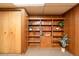 Built-in shelving unit with wood trim and adjacent closet space at 9100 Yucca Way, Thornton, CO 80229