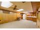 Basement area has ample space, kitchenette, and wall paneling at 9100 Yucca Way, Thornton, CO 80229