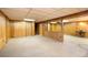 Spacious basement with wood paneled walls and neutral carpeting throughout at 9100 Yucca Way, Thornton, CO 80229