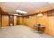 Spacious basement featuring wood paneled walls, and table at 9100 Yucca Way, Thornton, CO 80229