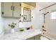 Charming bathroom featuring subway tile and an olive green vanity with white marble countertop at 9100 Yucca Way, Thornton, CO 80229