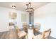 Bright dining room with hardwood floors, round table, and modern light fixture at 9100 Yucca Way, Thornton, CO 80229
