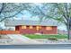 Charming brick home with a well-manicured lawn, long driveway, and a covered carport at 9100 Yucca Way, Thornton, CO 80229