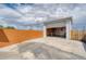 Detached garage with a concrete driveway and a partially open door showcasing its potential at 9100 Yucca Way, Thornton, CO 80229