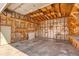 Spacious garage interior featuring exposed wooden framing, concrete flooring, and an attached workbench at 9100 Yucca Way, Thornton, CO 80229