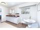 Bright kitchen features stainless sink, tile backsplash, and dining nook with natural light at 9100 Yucca Way, Thornton, CO 80229