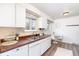 Bright kitchen features stainless sink, tile backsplash, and dining nook with natural light at 9100 Yucca Way, Thornton, CO 80229