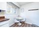 Bright kitchen nook features a modern table and natural light from the window at 9100 Yucca Way, Thornton, CO 80229