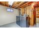 Finished basement laundry area features modern washer and dryer, storage, and access to utilities at 9100 Yucca Way, Thornton, CO 80229
