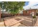 Private backyard with brick building, brick patio, and privacy fence at 827 S Sherman St, Denver, CO 80209