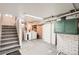 Basement with stairs, laundry area, painted brick, and updated fixtures at 827 S Sherman St, Denver, CO 80209
