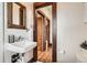 Bathroom with white sink, wood framed mirror and doorway view to the next room at 827 S Sherman St, Denver, CO 80209