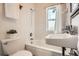 Bathroom featuring a bathtub with shower, tiled walls, and sink at 827 S Sherman St, Denver, CO 80209