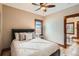 Bedroom with a queen bed dressed in white linens with lots of decorative pillows and a ceiling fan at 827 S Sherman St, Denver, CO 80209