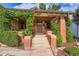 Charming brick home featuring a cozy front porch adorned with climbing greenery and a welcoming entrance at 827 S Sherman St, Denver, CO 80209
