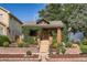Charming home with manicured front yard, featuring brick accents and lush landscaping at 827 S Sherman St, Denver, CO 80209