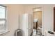 Bright kitchen with white appliances and cabinets, and access to the upper floor stairs at 827 S Sherman St, Denver, CO 80209