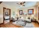 Cozy living room with hardwood floors, large windows, and comfortable seating, filled with natural light at 827 S Sherman St, Denver, CO 80209
