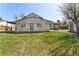 Spacious backyard featuring lush green grass, and patio with outdoor seating at 7391 S Marion St, Centennial, CO 80122