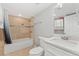 Well-maintained bathroom with a tub and shower combination, modern vanity, and neutral tile at 7391 S Marion St, Centennial, CO 80122