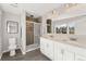 Bright bathroom with double sinks and tiled shower at 7391 S Marion St, Centennial, CO 80122
