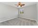 Simple bedroom provides carpet, a ceiling fan, and great light from the window at 7391 S Marion St, Centennial, CO 80122