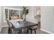 Cozy dining area with a dark wood table, bench seating, and a large bay window at 7391 S Marion St, Centennial, CO 80122