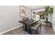Bright dining area featuring a modern table and bench, lit by a large bay window at 7391 S Marion St, Centennial, CO 80122