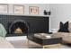 Close-up of a modern fireplace with black brick surround and arched opening, enhanced by stylish decor at 7391 S Marion St, Centennial, CO 80122