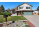 Charming two-story home featuring a manicured lawn, brick accents, and a well-kept garden at 7391 S Marion St, Centennial, CO 80122