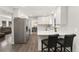 Bright kitchen with stainless steel fridge, white cabinets, and bar stool seating area at 7391 S Marion St, Centennial, CO 80122