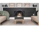Cozy living room with a brick fireplace, mantle decor, and stylish coffee table at 7391 S Marion St, Centennial, CO 80122