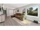 Inviting living room featuring large windows, plush seating, and laminate wood flooring at 7391 S Marion St, Centennial, CO 80122