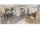 Spacious living room with hardwood floors, a gray sofa, and access to dining and kitchen areas at 7391 S Marion St, Centennial, CO 80122