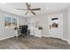 Bright home office with built-in desk and cabinets, ceiling fan, and hardwood floors at 7391 S Marion St, Centennial, CO 80122